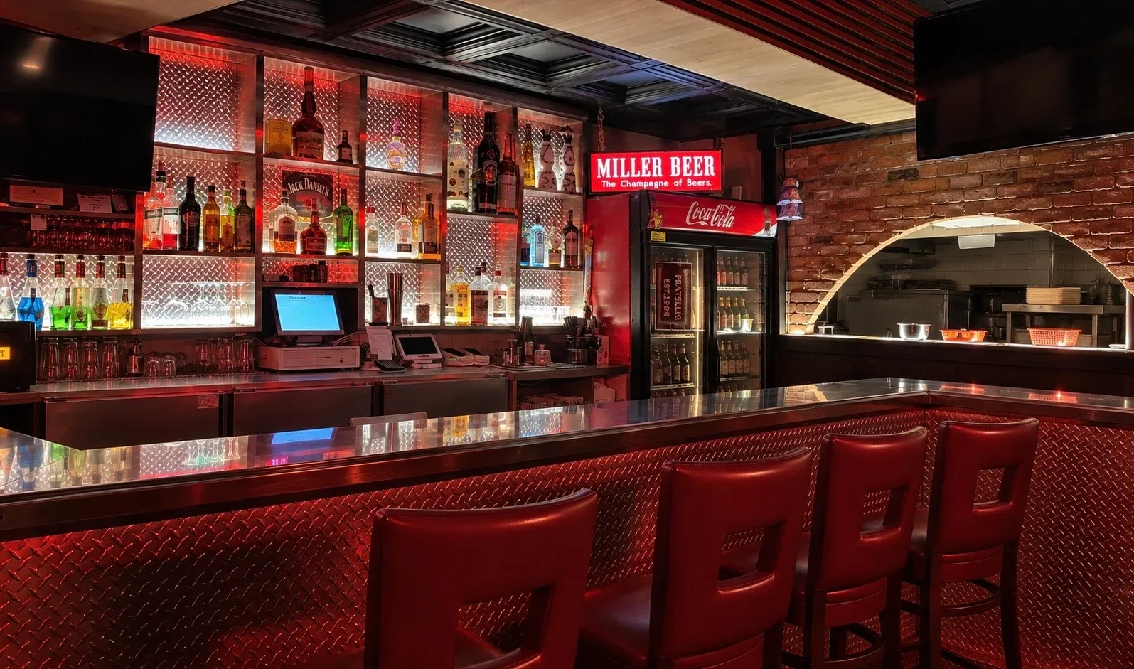 Fratelli’s licensed bar with red seating and illuminated shelves