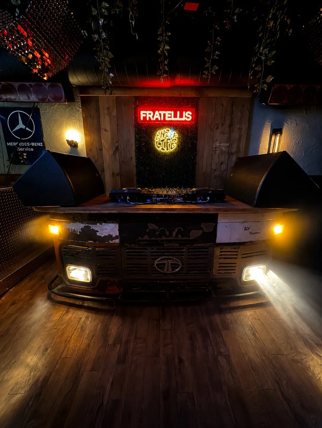 Fratelli’s distinctive red Tata bus front converted into a DJ booth beneath its neon sign