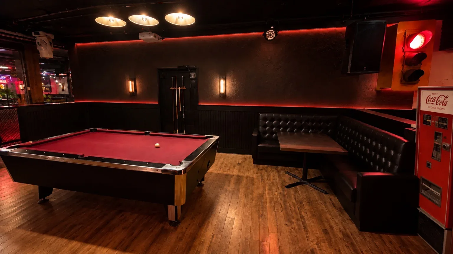 The actual Fratelli’s lounge, with wood floors, leather seating and a red pool table