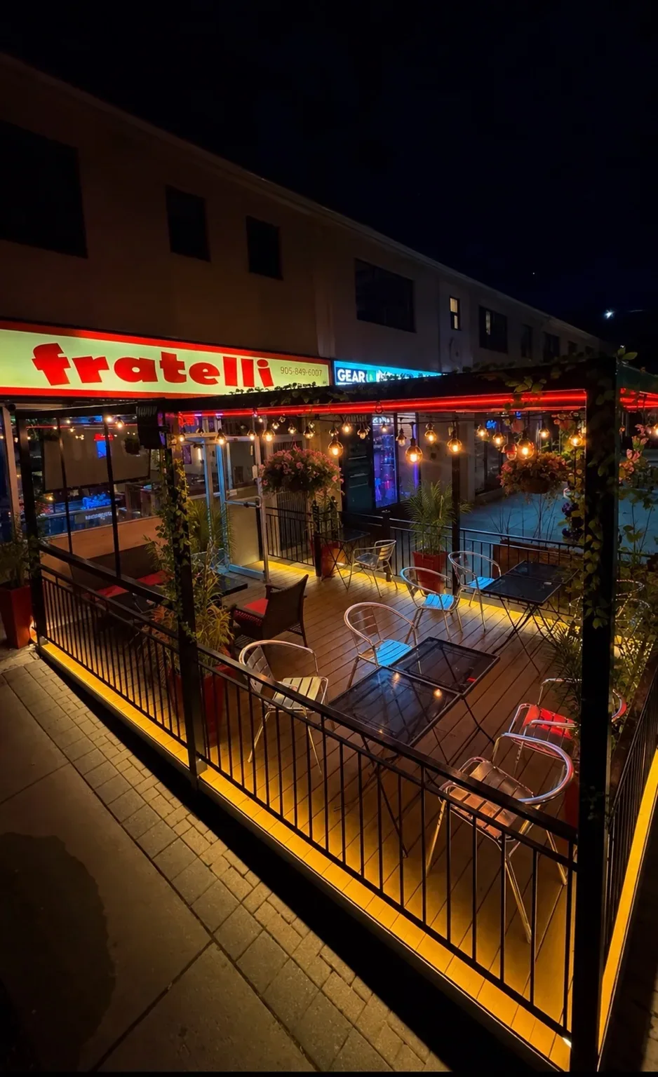 The private patio at Fratelli’s with outdoor seating and string lights